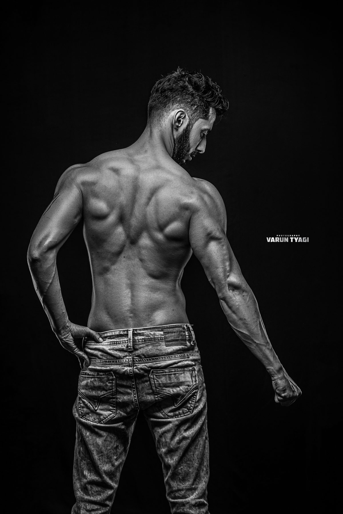 Varun, back double biceps pose in black and white