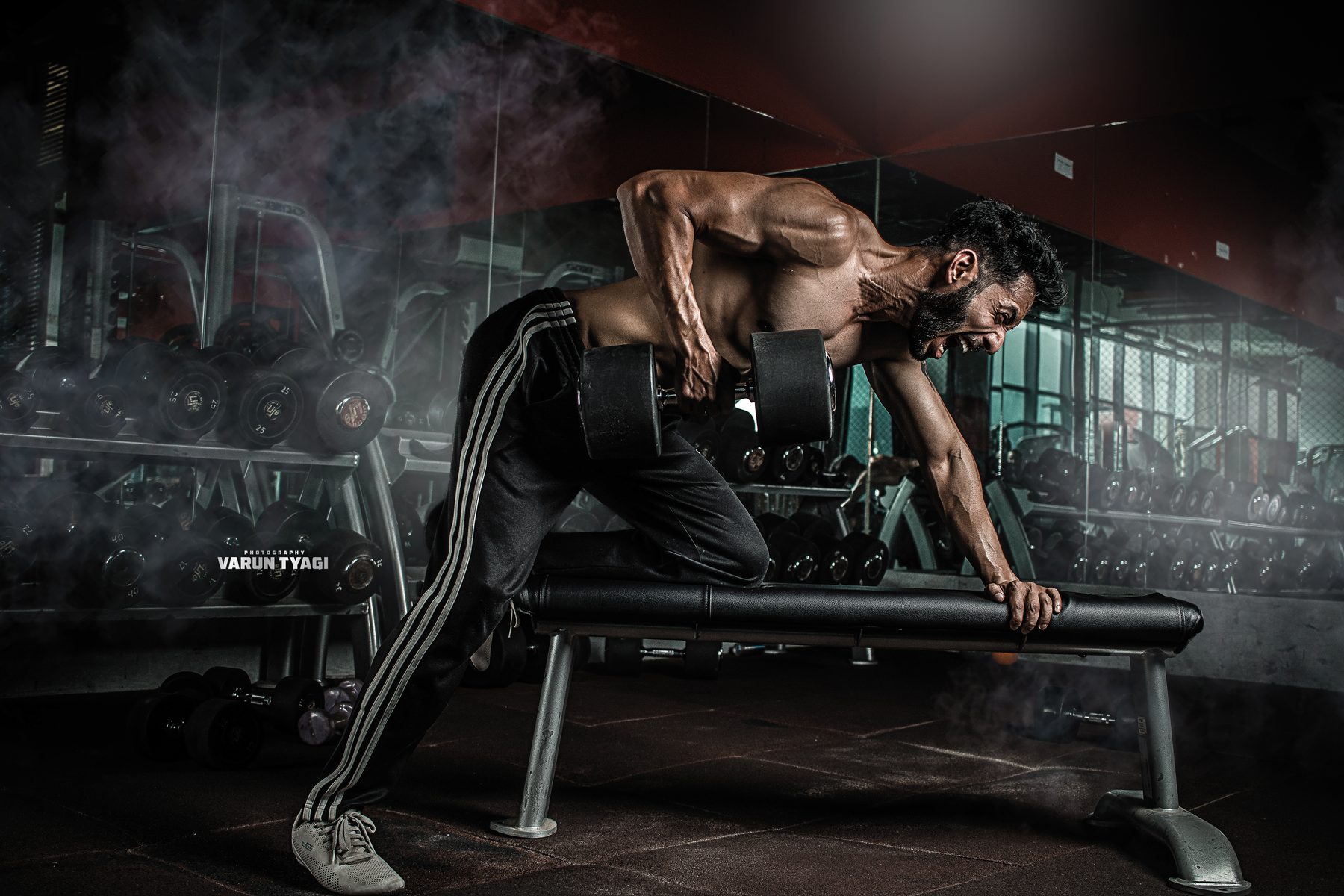 Varun performing a heavy dumbbell row